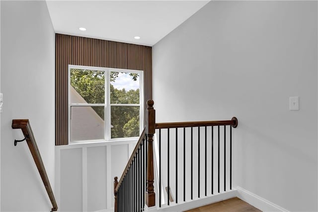 stairs featuring hardwood / wood-style floors