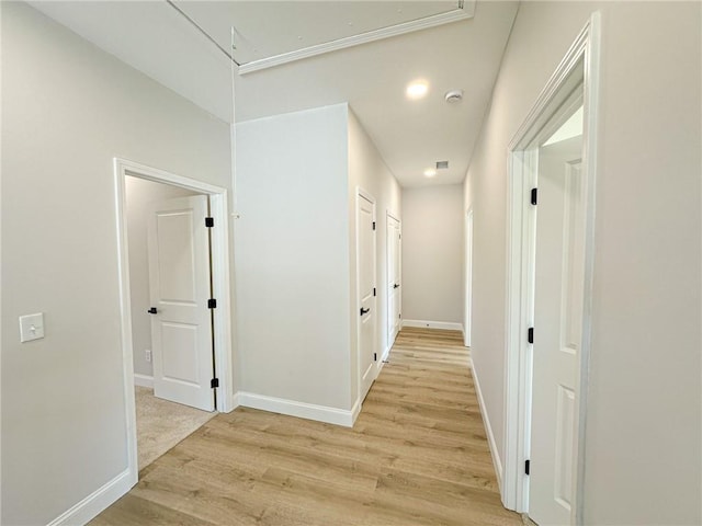 corridor with light wood-type flooring