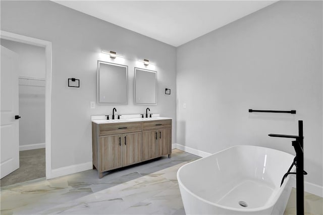 bathroom with a tub to relax in and vanity