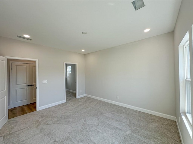 unfurnished bedroom with light colored carpet