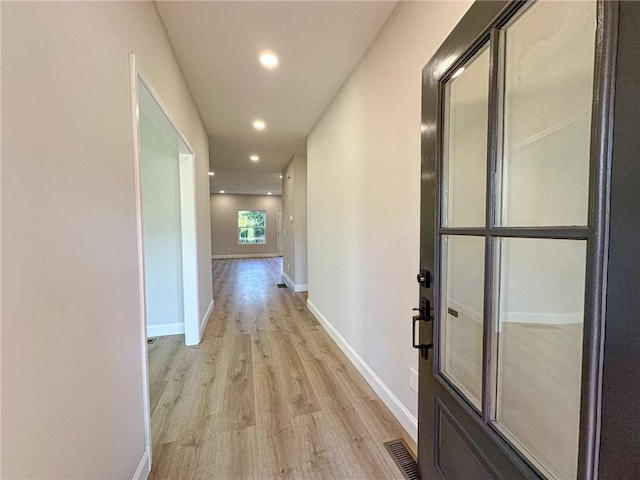 corridor featuring light hardwood / wood-style floors