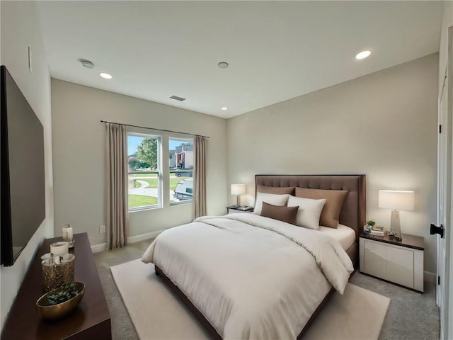 bedroom featuring light carpet