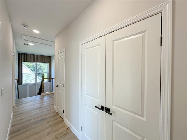 hall with light hardwood / wood-style flooring