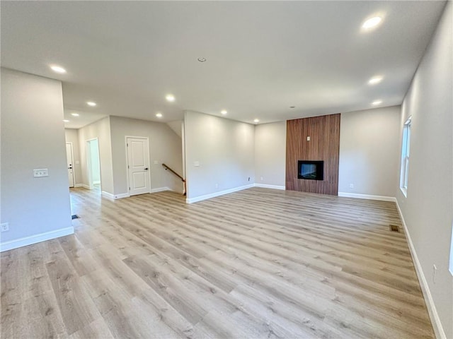 unfurnished living room featuring light hardwood / wood-style floors and a fireplace