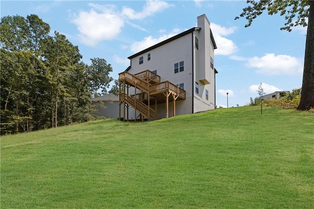 back of house featuring a yard and a wooden deck