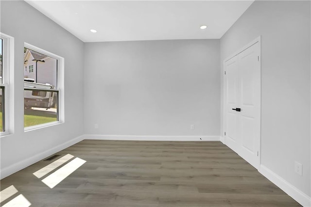 empty room featuring dark hardwood / wood-style flooring