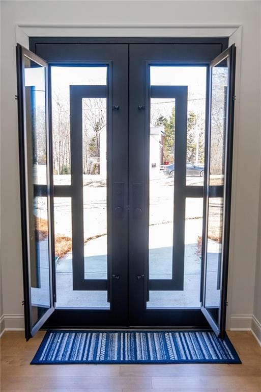 doorway to outside featuring hardwood / wood-style floors and french doors