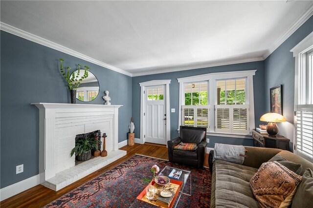 living area featuring a healthy amount of sunlight, crown molding, and wood finished floors