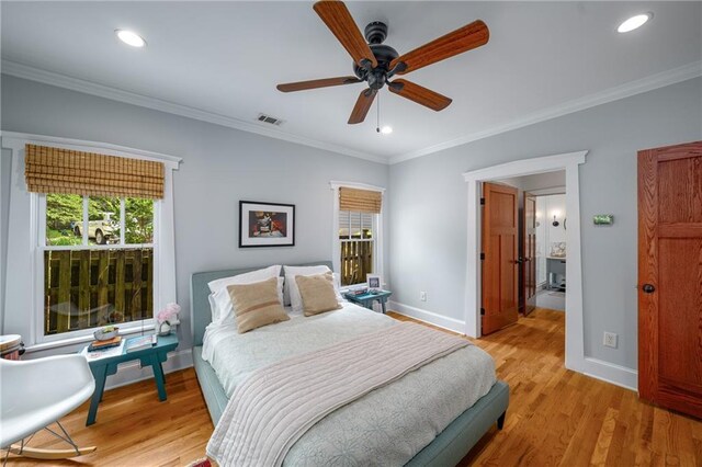 bedroom with visible vents, light wood-type flooring, baseboards, ornamental molding, and recessed lighting