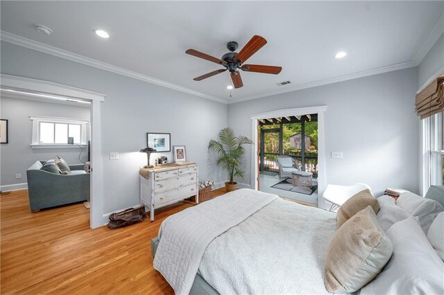 bedroom with visible vents, light wood-style floors, multiple windows, and access to exterior