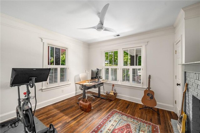 office space featuring a wealth of natural light, ceiling fan, hardwood / wood-style flooring, and visible vents