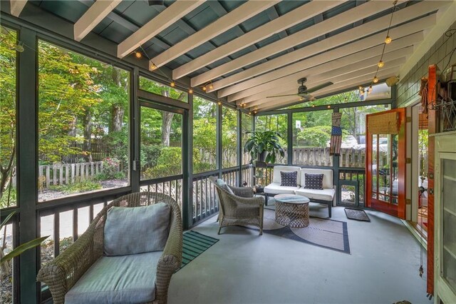 sunroom / solarium featuring ceiling fan and an outdoor hangout area