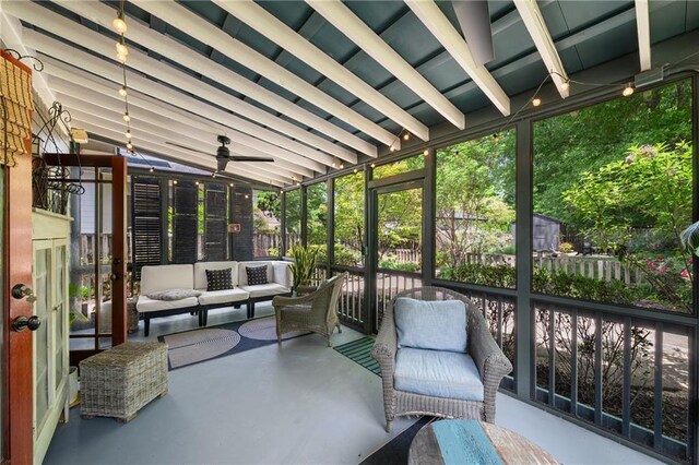 sunroom with ceiling fan and an outdoor living space