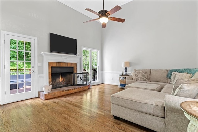 4381 Laurian Dr NW, Kennesaw, GA 30144 - living room with wood finished floors, a ceiling fan, a fireplace, a high ceiling, and baseboards