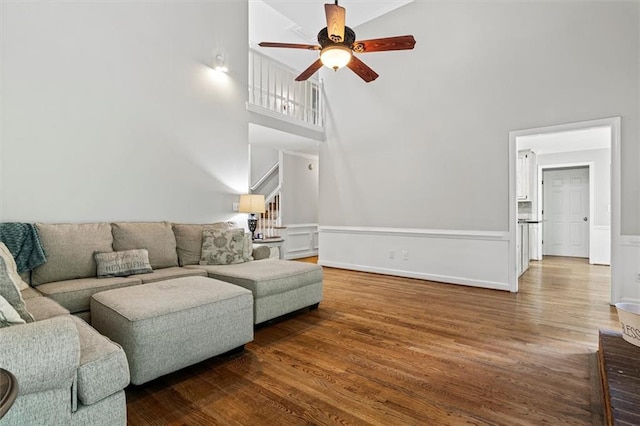 4381 Laurian Dr NW, Kennesaw, GA 30144 - living room with ceiling fan, a high ceiling, wood finished floors, and a wainscoted wall