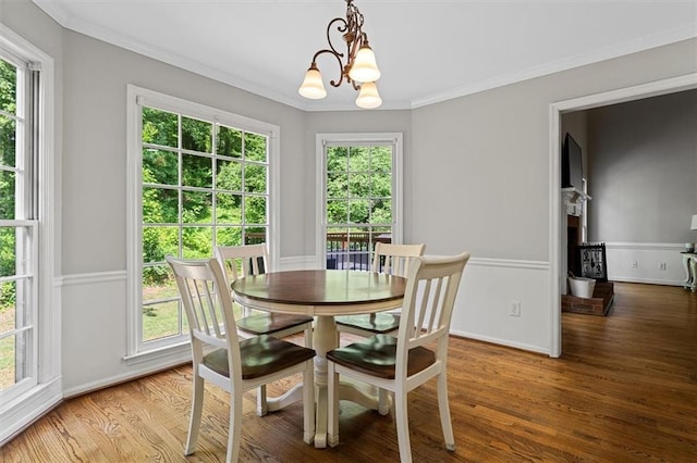 4381 Laurian Dr NW, Kennesaw, GA 30144 - dining area featuring a chandelier, crown molding, wood finished floors, and healthy amount of natural light