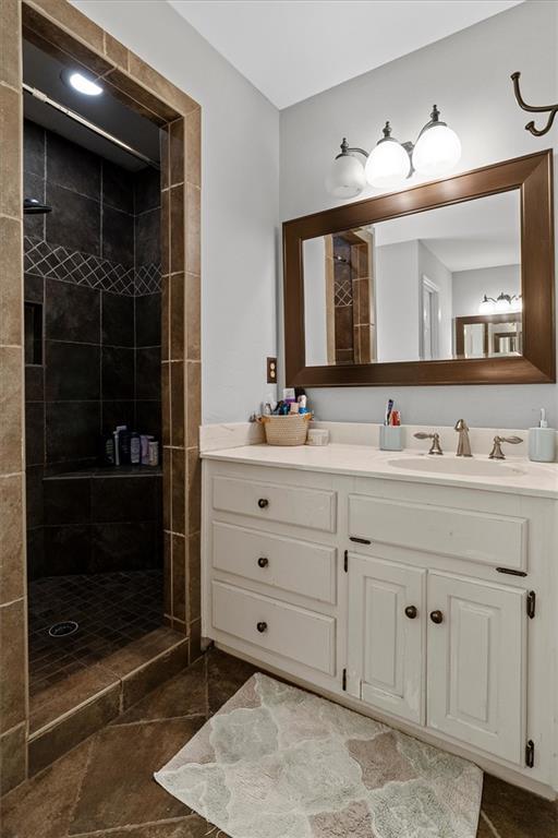 4381 Laurian Dr NW, Kennesaw, GA 30144 - bathroom featuring vanity and a tile shower