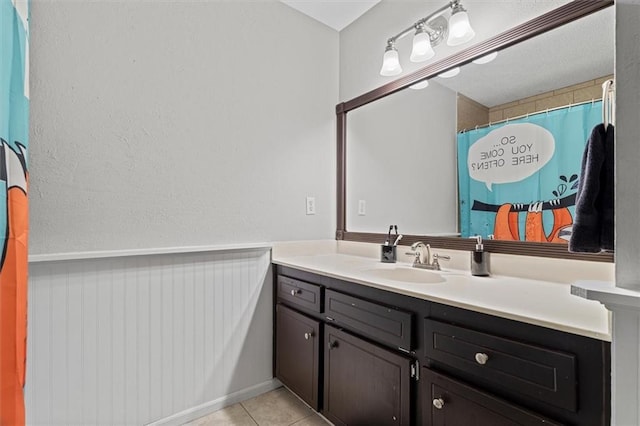 4381 Laurian Dr NW, Kennesaw, GA 30144 - bathroom with vanity, tile patterned floors, and a wainscoted wall