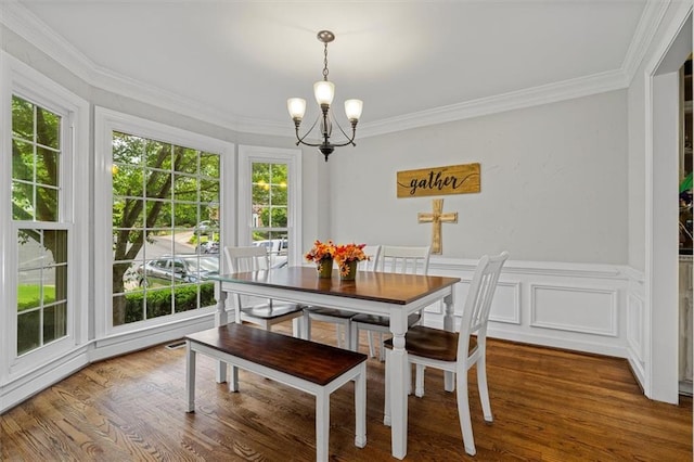 4381 Laurian Dr NW, Kennesaw, GA 30144 - dining space featuring a chandelier, plenty of natural light, ornamental molding, and wood finished floors