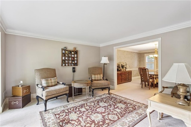 living area featuring light colored carpet, ornamental molding, a chandelier, and baseboards