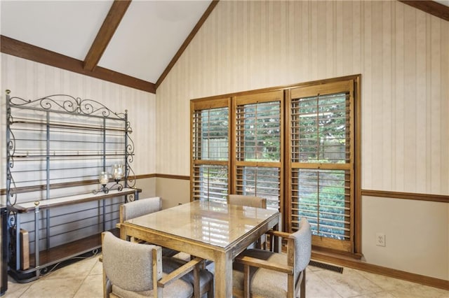 dining space with wallpapered walls and light tile patterned floors
