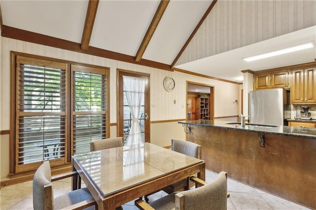 dining space with light tile patterned floors and crown molding