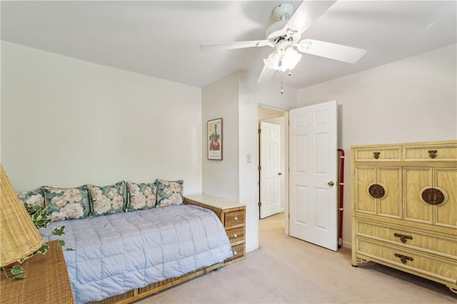 bedroom with light colored carpet and a ceiling fan