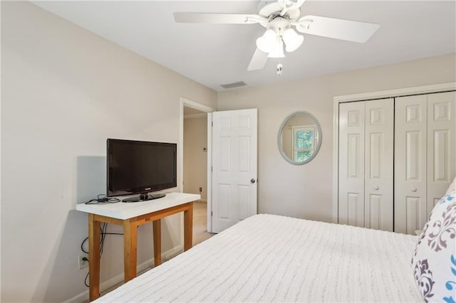 bedroom with a closet, ceiling fan, and baseboards