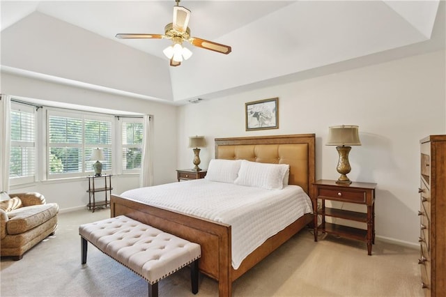 bedroom featuring light carpet, vaulted ceiling, baseboards, and ceiling fan