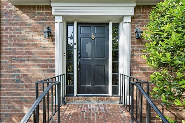 property entrance featuring brick siding