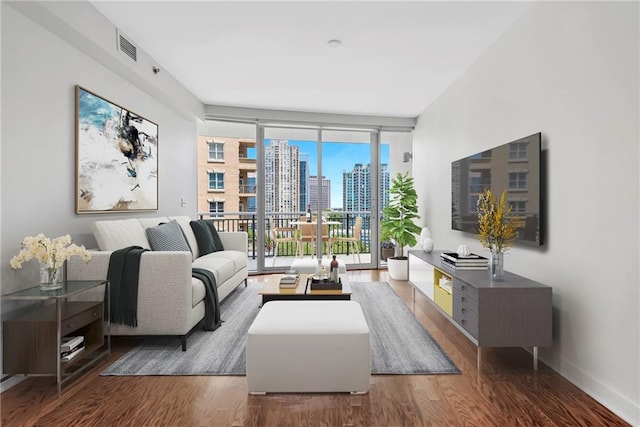 living room featuring hardwood / wood-style floors and a wall of windows