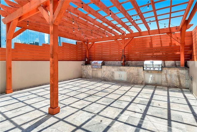 view of patio featuring a pergola, an outdoor kitchen, and a grill