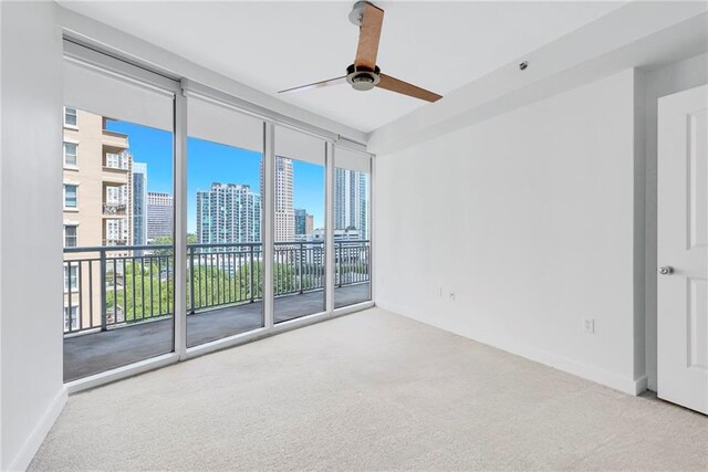 empty room with ceiling fan and carpet floors