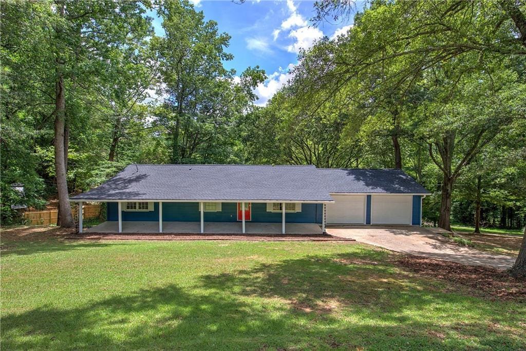 217 Water Tank Rd, Dallas, GA 30132 - view of front of home featuring a front lawn, covered porch, and a garage