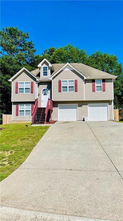 350 Fall View Ct, Winder, GA 30680 - raised ranch featuring a garage, driveway, and a front yard