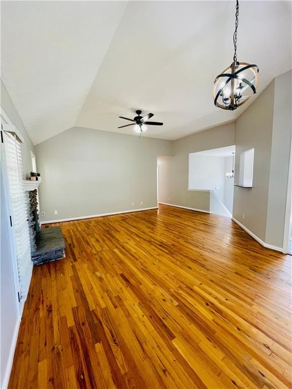 350 Fall View Ct, Winder, GA 30680 - unfurnished living room featuring lofted ceiling, a chandelier, hardwood / wood-style floors, and baseboards