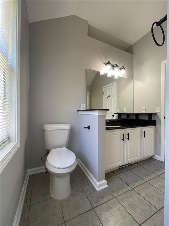 350 Fall View Ct, Winder, GA 30680 - bathroom featuring lofted ceiling, tile patterned flooring, vanity, toilet, and baseboards