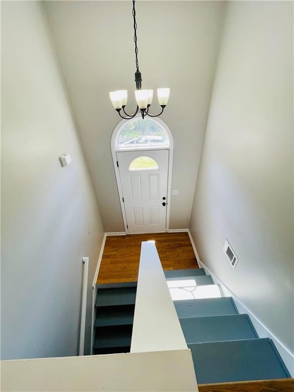 350 Fall View Ct, Winder, GA 30680 - entryway featuring a chandelier, wood finished floors, baseboards, and a towering ceiling