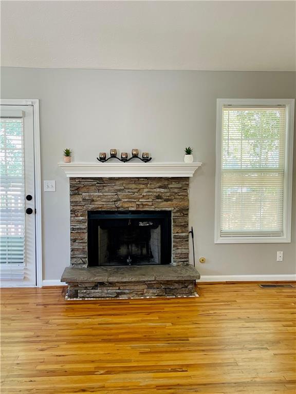 350 Fall View Ct, Winder, GA 30680 - detailed view of wood finished floors, a fireplace, and baseboards