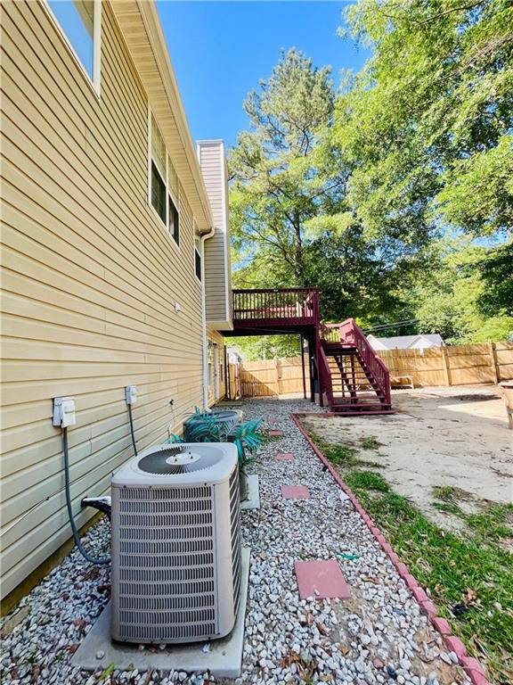 350 Fall View Ct, Winder, GA 30680 - fenced backyard with cooling unit and a deck