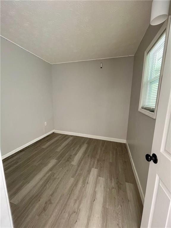 350 Fall View Ct, Winder, GA 30680 - unfurnished room featuring dark wood-style flooring, baseboards, and a textured ceiling