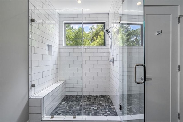 bathroom featuring a shower with door