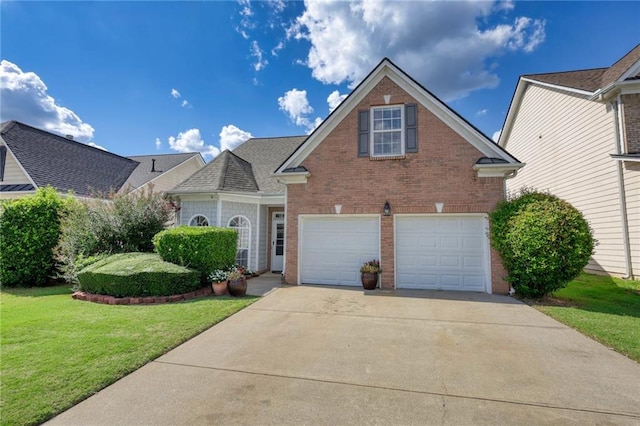 view of property with a garage and a front lawn