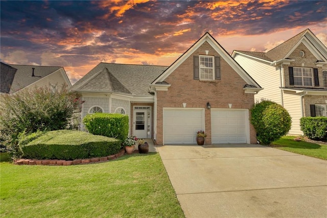 view of front of home with a garage and a yard