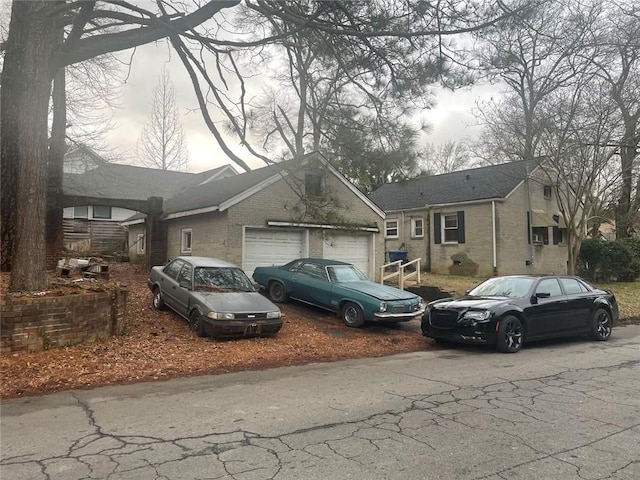 view of front of home with a garage and brick siding