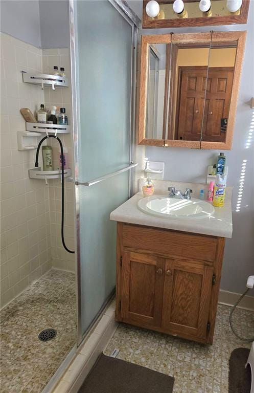 bathroom featuring vanity and an enclosed shower