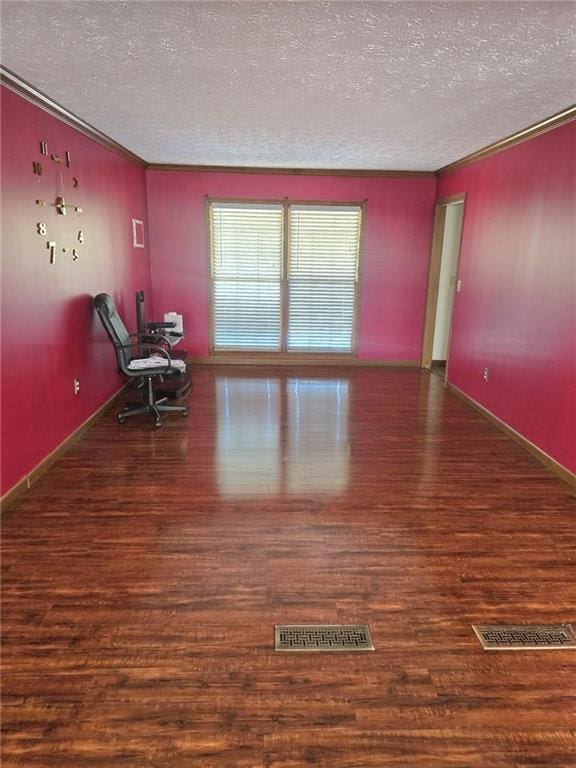 spare room with dark hardwood / wood-style flooring and a textured ceiling