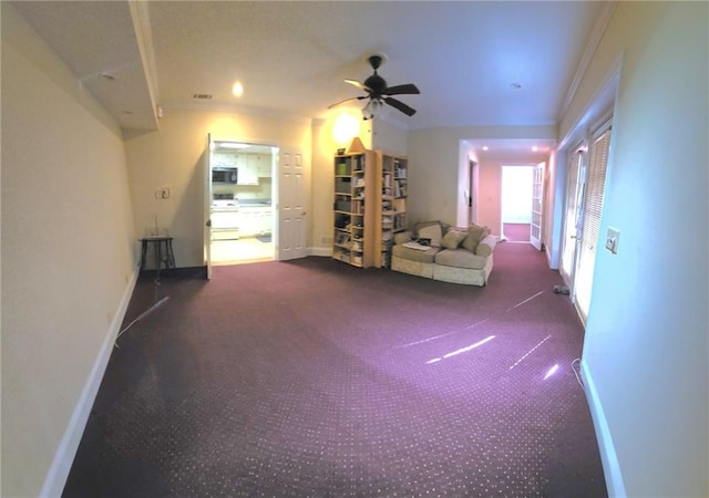 unfurnished living room featuring ceiling fan and ornamental molding