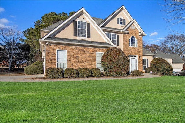 view of front facade featuring stone siding, stucco siding, and a front yard