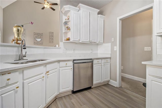 kitchen with light wood finished floors, white cabinetry, ceiling fan, and stainless steel dishwasher